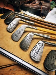 Des clubs de golf anciens avec le manche en bois et des têtes rénovées